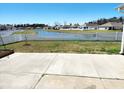 Tranquil backyard view featuring a white picket fence and a serene pond, offering privacy and charm at 3461 Holly Loop, Conway, SC 29527