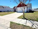 A well-maintained driveway leads to a charming home with a two-car garage and a beautifully landscaped yard at 3461 Holly Loop, Conway, SC 29527