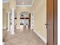 Expansive living room with tiled floors, large arched doorway, and bright natural light from large window at 360 Welcome Dr., Myrtle Beach, SC 29579