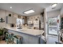 Well lit kitchen with stainless steel appliances and access to an outdoor deck at 3923 Gladiola Ct. # 204, Myrtle Beach, SC 29588