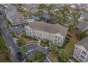Aerial view of a condo with community pool, landscaping, and parking at 4179 Hibiscus Dr. # 303, Little River, SC 29566