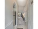 Hallway view into living area with carpet, tile and an arched doorway to kitchen at 4179 Hibiscus Dr. # 303, Little River, SC 29566