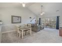 Bright living room with vaulted ceilings, dining area, and sliding glass doors to a balcony at 4179 Hibiscus Dr. # 303, Little River, SC 29566