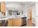 Spacious open kitchen with a stainless-steel dishwasher, and modern lighting at 4648 Greenbriar Dr. # D7, Little River, SC 29566