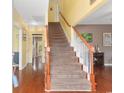 Welcoming foyer with a staircase featuring wood handrails and white balusters leading to the upper level at 470 Spring Lake Dr., Myrtle Beach, SC 29579