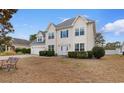 Charming two-story home featuring blue shutters, an attached two-car garage, and a well-maintained lawn at 470 Spring Lake Dr., Myrtle Beach, SC 29579