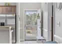 Inviting entryway featuring a storm door to let light in, neutral decor, and a stainless steel refrigerator at 4865 Luster Leaf Circle # 304, Myrtle Beach, SC 29577