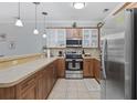 Well-equipped kitchen featuring wood cabinets, stainless appliances, a breakfast bar, and stylish pendant lighting at 4865 Luster Leaf Circle # 304, Myrtle Beach, SC 29577
