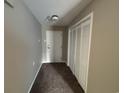 Neutral hallway with closet and door, providing a simple transition into the home at 5001 Little River Rd. # E-312, Myrtle Beach, SC 29577