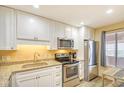 Well-lit kitchen featuring stainless steel appliances, granite countertops, and white cabinets at 5507 N Ocean Blvd. # 304, Myrtle Beach, SC 29577