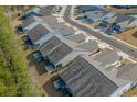 Drone view of a residential community featuring well-maintained townhomes, manicured lawns, and paved streets at 5987 Tramonto St., Myrtle Beach, SC 29577