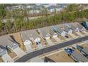 Overhead shot of a neighborhood with well-kept homes, manicured lawns, and tree-lined streets at 5987 Tramonto St., Myrtle Beach, SC 29577