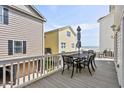 Enjoy the outdoors on this spacious deck, perfect for entertaining with views of nearby houses and a glimpse of the ocean at 6001- 1084 S Kings Highway, Myrtle Beach, SC 29575