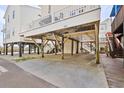 Spacious covered parking area under a beach house, providing ample space and protection from the elements at 6001- 1084 S Kings Highway, Myrtle Beach, SC 29575