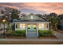 Inviting yellow home with a spacious front porch, perfect for relaxing evenings at 6514 Anchors Bend Dr Sw, Ocean Isle Beach, NC 28469