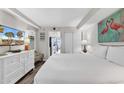 Cozy bedroom with flamingo art, white furniture, and tv at 6804 N Ocean Blvd. # 1623, Myrtle Beach, SC 29572
