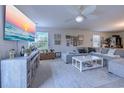 Bright living room with comfortable seating, television, and view to the backyard at 693 Landmark Cove Rd., Carolina Shores, NC 28467