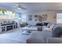 Spacious living room featuring a large sectional sofa, ceiling fan, and television at 693 Landmark Cove Rd., Carolina Shores, NC 28467