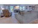 Cozy living room with reclining chair, soft carpet, and an entertainment center at 693 Landmark Cove Rd., Carolina Shores, NC 28467