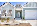 Inviting home entrance with a light blue exterior, well-kept landscaping, and white trim at 707 Culbertson Ave., Myrtle Beach, SC 29577