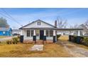 Charming one-story home featuring black-and-white accents, a covered carport, and a well-maintained lawn at 708 Bobby L. Davis Blvd., Marion, SC 29571
