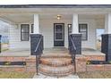 Inviting front porch with brick steps and black iron railing, showcasing the home's entrance at 708 Bobby L. Davis Blvd., Marion, SC 29571