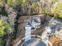Aerial view of a home with a circular driveway and beautifully landscaped yard in a wooded community at 818 Mourning Dove Dr., Myrtle Beach, SC 29577