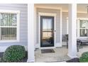 Inviting front door with decorative sidelights and a welcome mat on a covered porch at 818 Mourning Dove Dr., Myrtle Beach, SC 29577