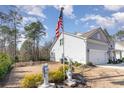 Side yard view of a home with lawn decor and an American flag at 818 Mourning Dove Dr., Myrtle Beach, SC 29577