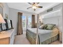 Cozy bedroom featuring a four-poster bed, soft natural light, and neutral décor at 8217 Sandlapper Way, Myrtle Beach, SC 29572