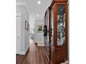 Inviting entryway showcases rich hardwood floors and a beautiful display cabinet with glass shelving at 8217 Sandlapper Way, Myrtle Beach, SC 29572