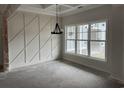 Living room with a large window and decorative wall paneling at 1007 Brood Ct., Conway, SC 29526