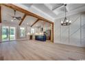 Spacious living room with high ceilings, wooden beams, hardwood floors, and an open concept kitchen at 1007 Brood Ct., Conway, SC 29526