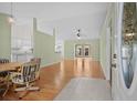 Open concept living with dining area, hardwood floors, and views into the adjacent living spaces at 1021 Dunraven Ct., Conway, SC 29527