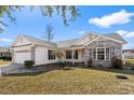 Inviting single-story home with white siding, brick accents, and a well-maintained front lawn at 1021 Dunraven Ct., Conway, SC 29527