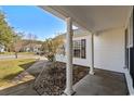 Welcoming covered front porch featuring white columns and a decorative rock garden at 1021 Dunraven Ct., Conway, SC 29527