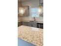 Modern kitchen featuring granite countertops, stainless steel appliances, and stylish pendant lighting at 1091 Forest Bend Dr., Calabash, NC 28467