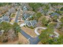 An aerial view highlights a home nestled within a lush, green neighborhood at 1110 Links Rd., Myrtle Beach, SC 29575