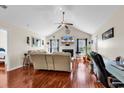 Bright living room with vaulted ceiling, fireplace, ceiling fan, and rich hardwood floors at 1166 Bethpage Dr., Myrtle Beach, SC 29579