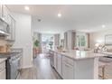 Modern kitchen overlooking a dining area with a sofa in a living area at 140 Leyland Cypress Dr, Conway, SC 29527