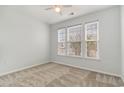 Neutral bedroom with plush carpet, a ceiling fan, and three large windows offering natural light at 156 Parmelee Dr. # B, Murrells Inlet, SC 29576