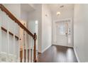 Bright foyer features hardwood floors, a staircase with wooden railing, and a decorative front door at 156 Parmelee Dr. # B, Murrells Inlet, SC 29576