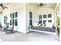 Inviting porch featuring a cozy daybed swing and comfortable rocking chairs at 1801 Tryon Dr, Myrtle Beach, SC 29588