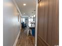 Inviting hallway view into a stylish kitchen with a large island, pendant lighting, and an open living area at 201 N 76Th Ave. N # B-2, Myrtle Beach, SC 29572