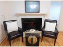 Cozy living room with a decorative fireplace, hardwood floors, and comfortable seating arrangement at 223 Greentown Rd., Georgetown, SC 29440