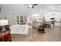 Open-concept living room with plenty of natural light, wood floors, and a comfortable seating arrangement at 250 Ole Maple St., Loris, SC 29569