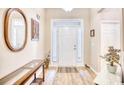 Bright entryway features hardwood floors, decorative mirror, and white front door at 263 Burchwood Ln., Myrtle Beach, SC 29588