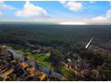 Aerial view showcases property near waterway with a densely forested landscape and distant ocean views at 270 Georgetown Dr., Pawleys Island, SC 29585