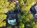 Aerial shot of a home with a backyard pool surrounded by lush greenery and mature trees at 270 Georgetown Dr., Pawleys Island, SC 29585