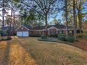 Brick home showcasing a well-manicured front lawn with mature trees providing ample shade at 270 Georgetown Dr., Pawleys Island, SC 29585